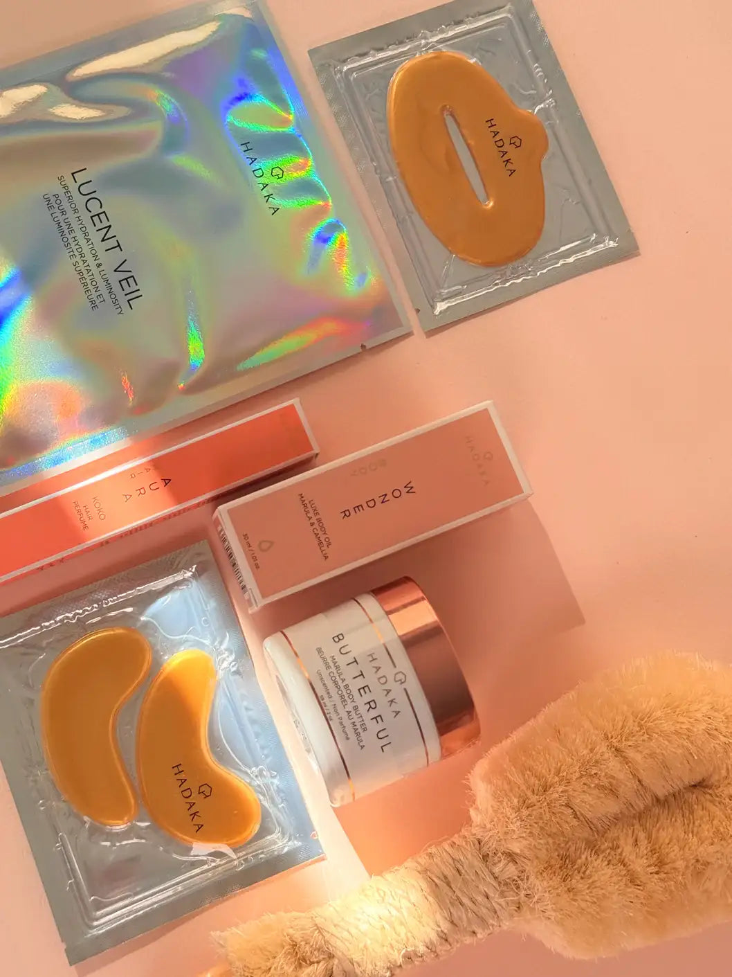 Skin & Hair Discovery Set by Hadaka Canada flat lay with skincare and hair products on a peach background