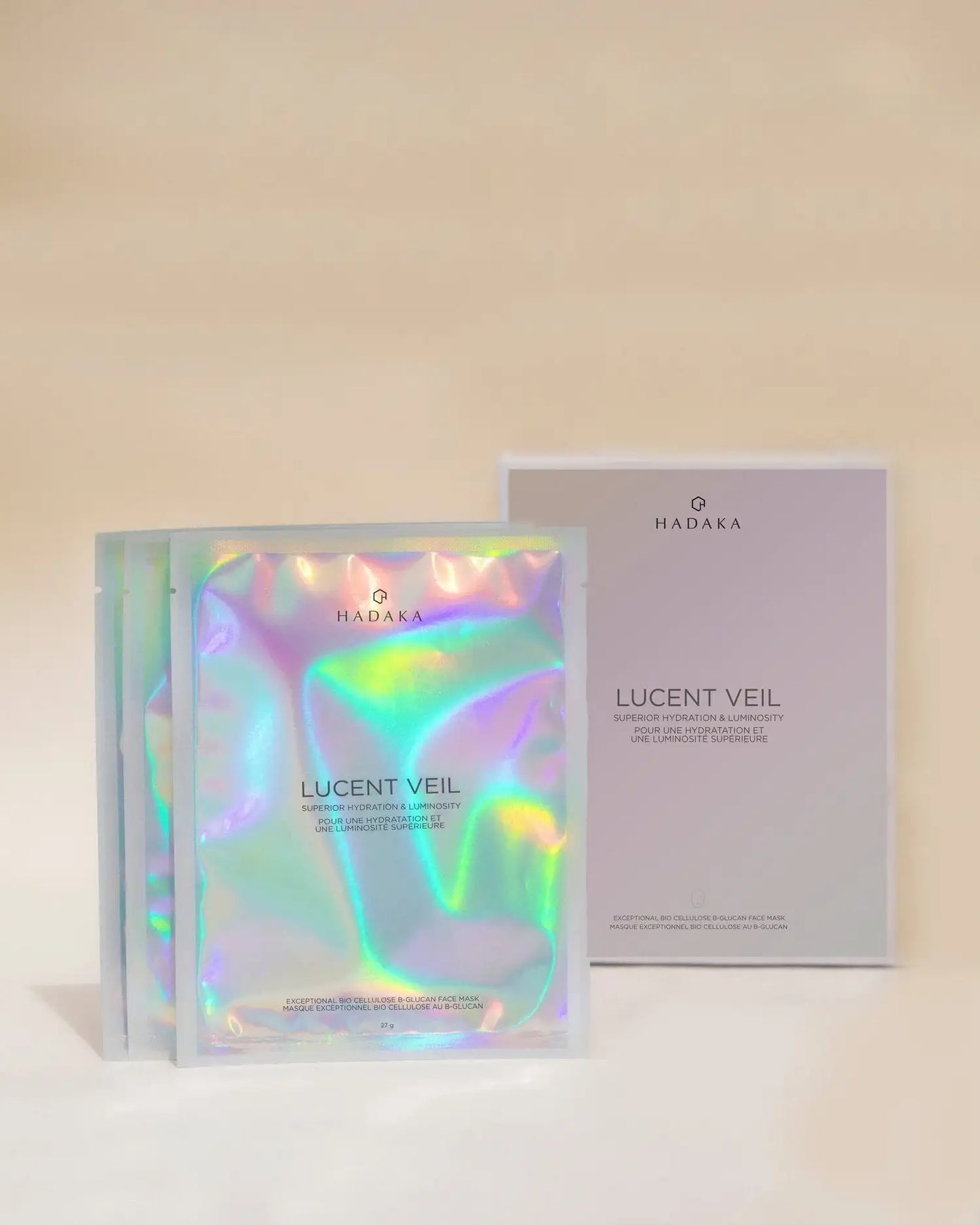 Iridescent Lucent Veil hydrating face mask pouches and box on a neutral background