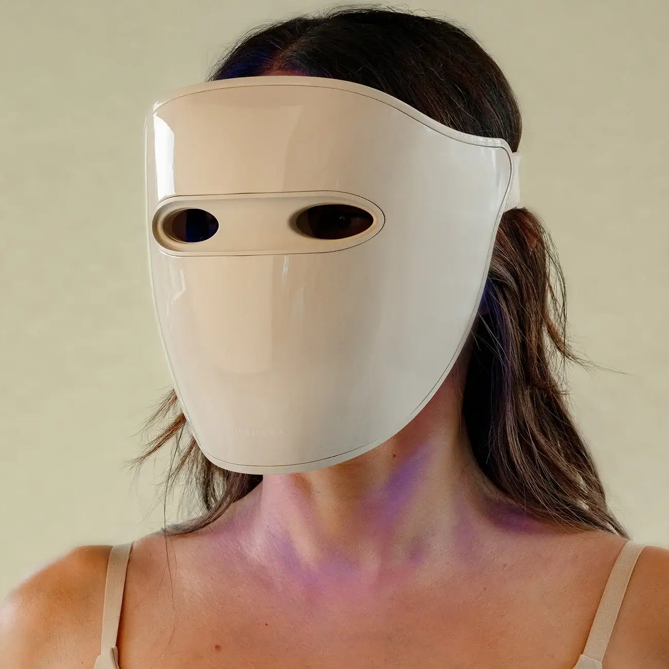 Person wearing a LED light Therapy mask with oval eye holes