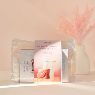 Hadaka Radiance Ritual Kit with MODELA EMS & LED Device and BEAUFACE Tri-Peptide Cream on a light pink background with decorative elements.