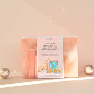 Canadian beauty skin & hair care gift set with dry brush, mask, and oils on a decorative shelf with soft lighting