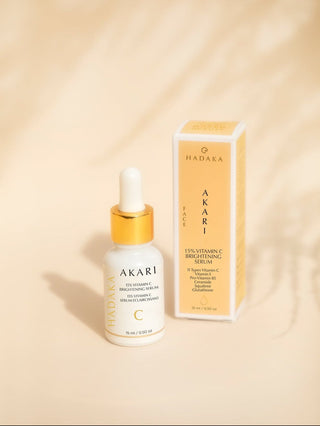 Akari skincare serum bottle with dropper and packaging on a beige background